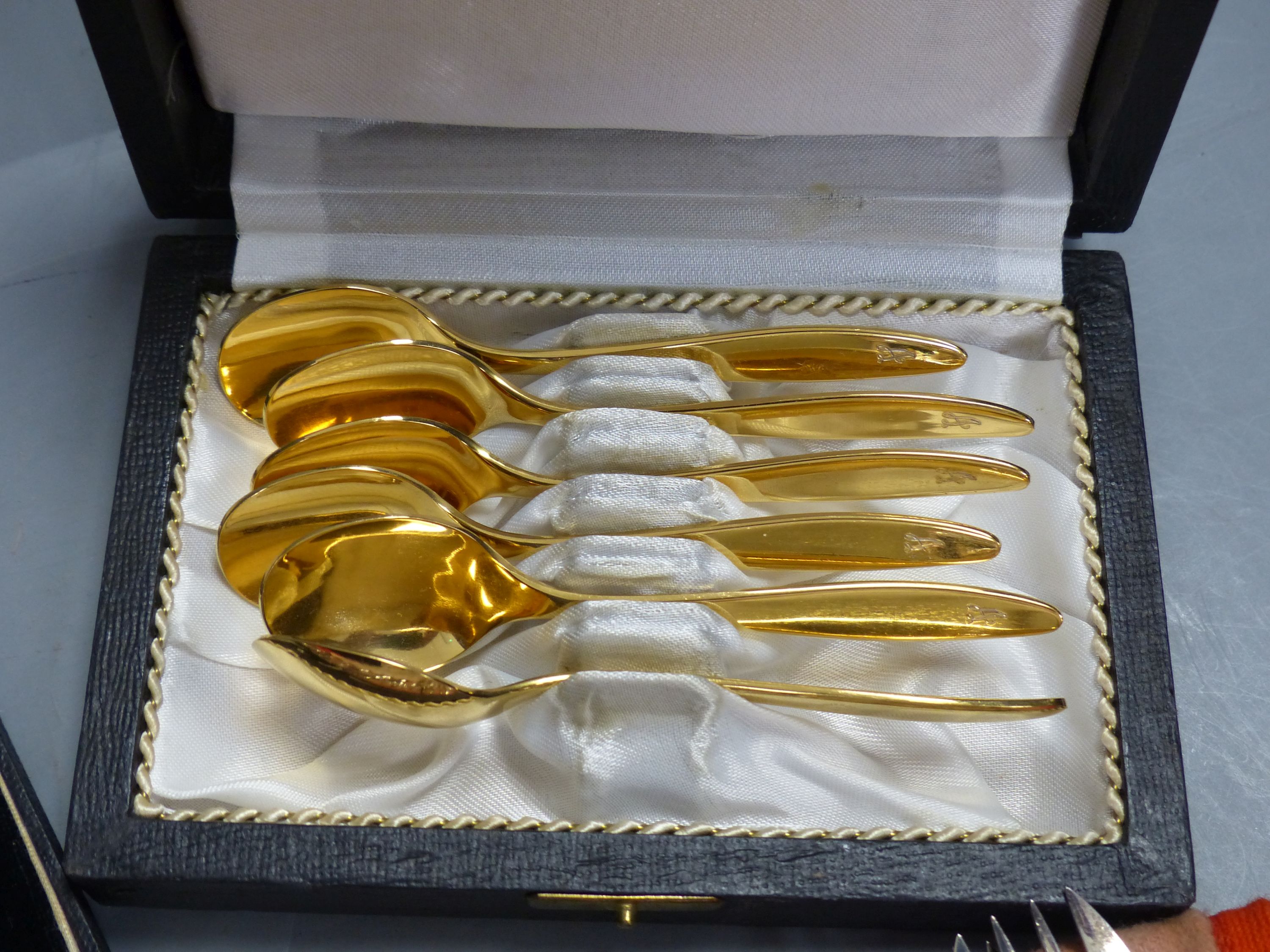 A set of twelve Christofle forks, a cased set of English coffee spoons and a set of Solingen gold-plated spoons.